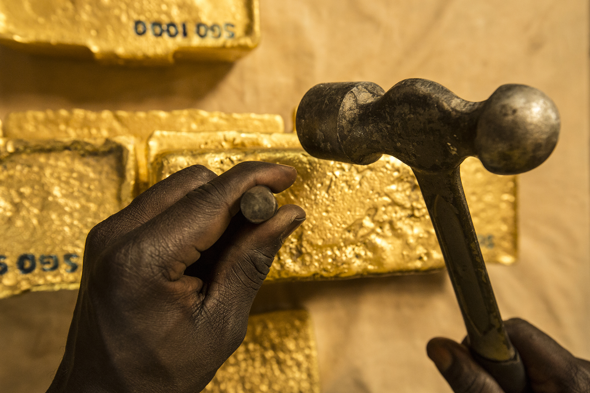  Stamping Newly Poured Gold Bars, Africa, 2012.&nbsp; Edition of 3. 