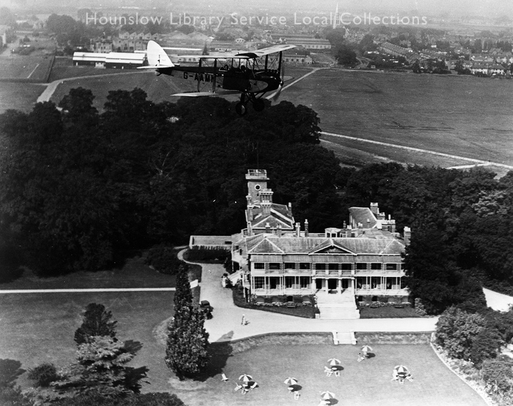 Hanworth-Air-Park,-the-clubhouse-from-the-air-with-bi-plane-(LS990)--1930's.jpg