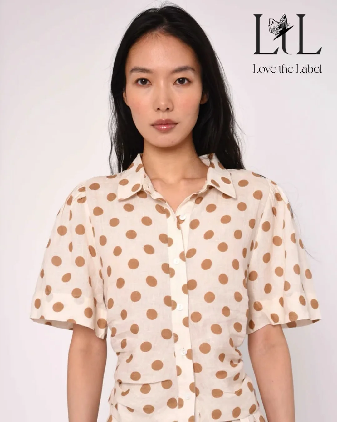 Love The Label - Sylvan Top In Jane Polka Dot. Featuring Ruched Side Seams And A Classic Collar.