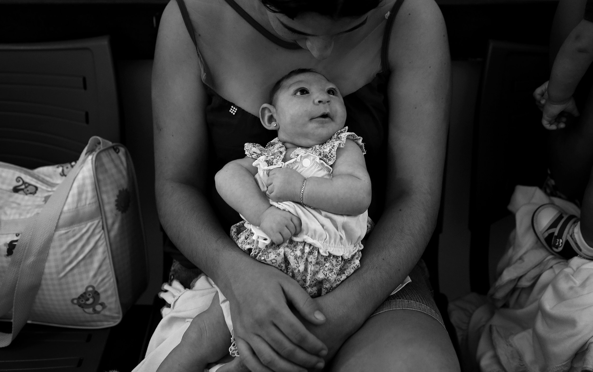  Maria Carolina Silva Floa, age 20, holds her baby, Maria Gabriela Silva Alves, 2 months, who was born with microcephaly, as she waits for her daughter’s physiotherapy appointment at Pedro 1 Municipal Hospital in Campina Grande, Brazil. Maria and oth