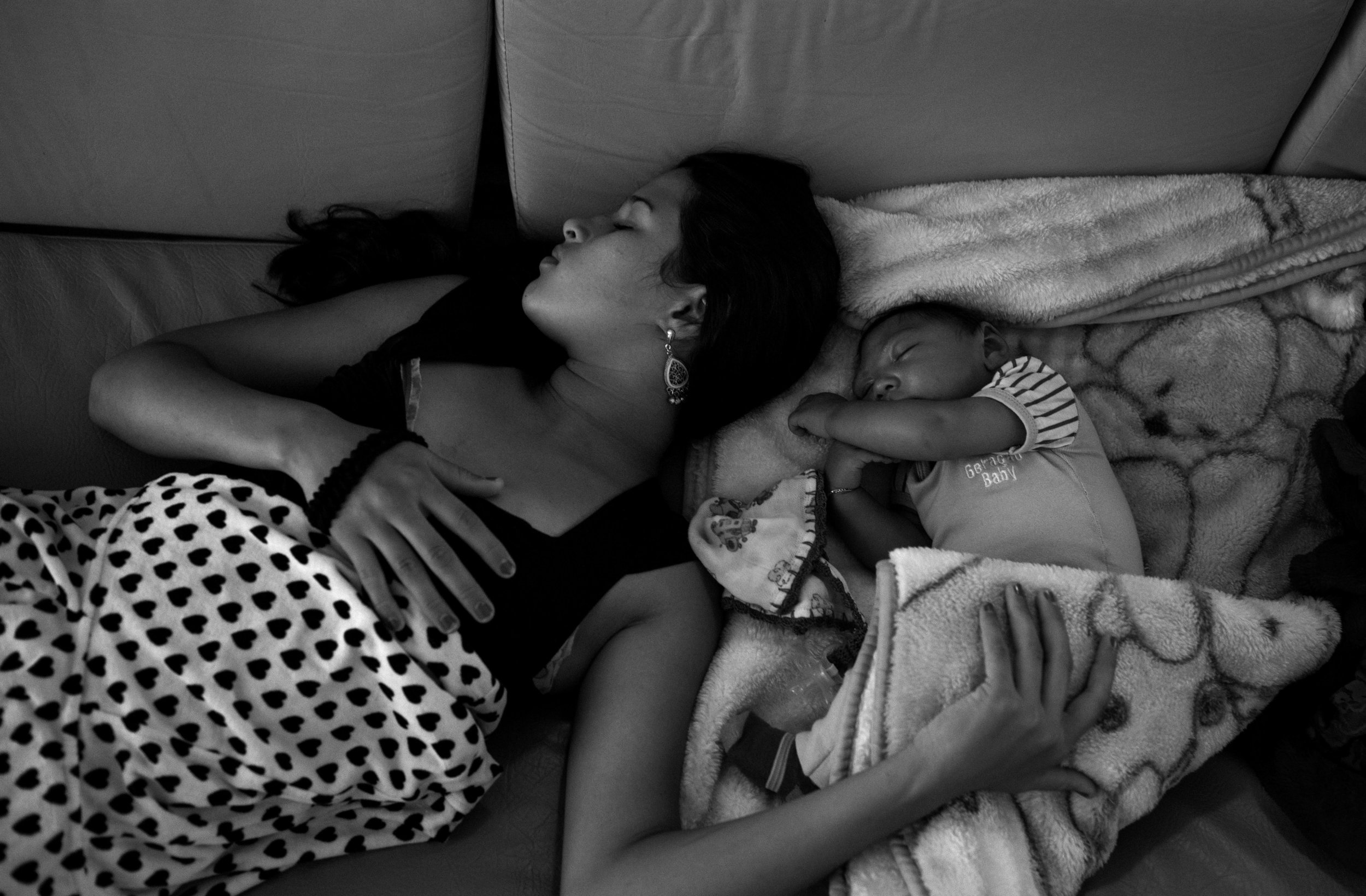  Kalissandra de Olivera, age 17, naps next to her son in a hallway of Pedro 1 Municipal Hospital. Between medical exams, physiotherapy appointments, and support group meetings, parents of babies with microcephaly spend long hours — for several days e