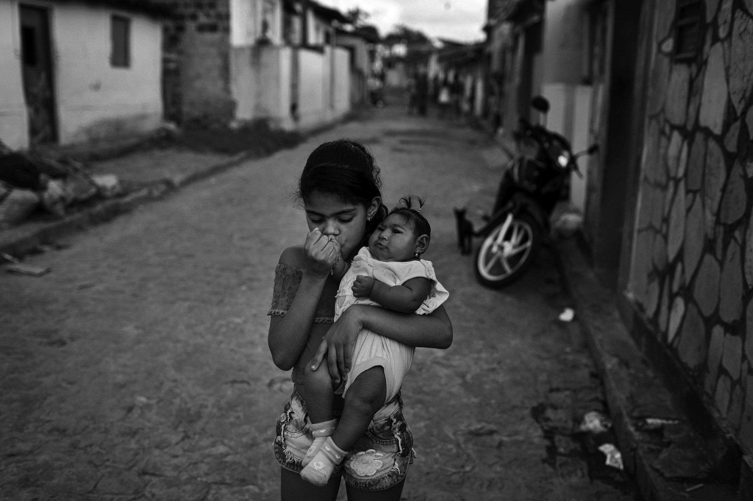  Evellyn Mendes Santos, age 9, kisses her baby sister, Heloyse, who was born with microcephaly, outside of their home in Joao Pessoa, Brazil. “My biggest dream was to have two girls,” their mother, Maria da Luz Mendes Santos, said.    