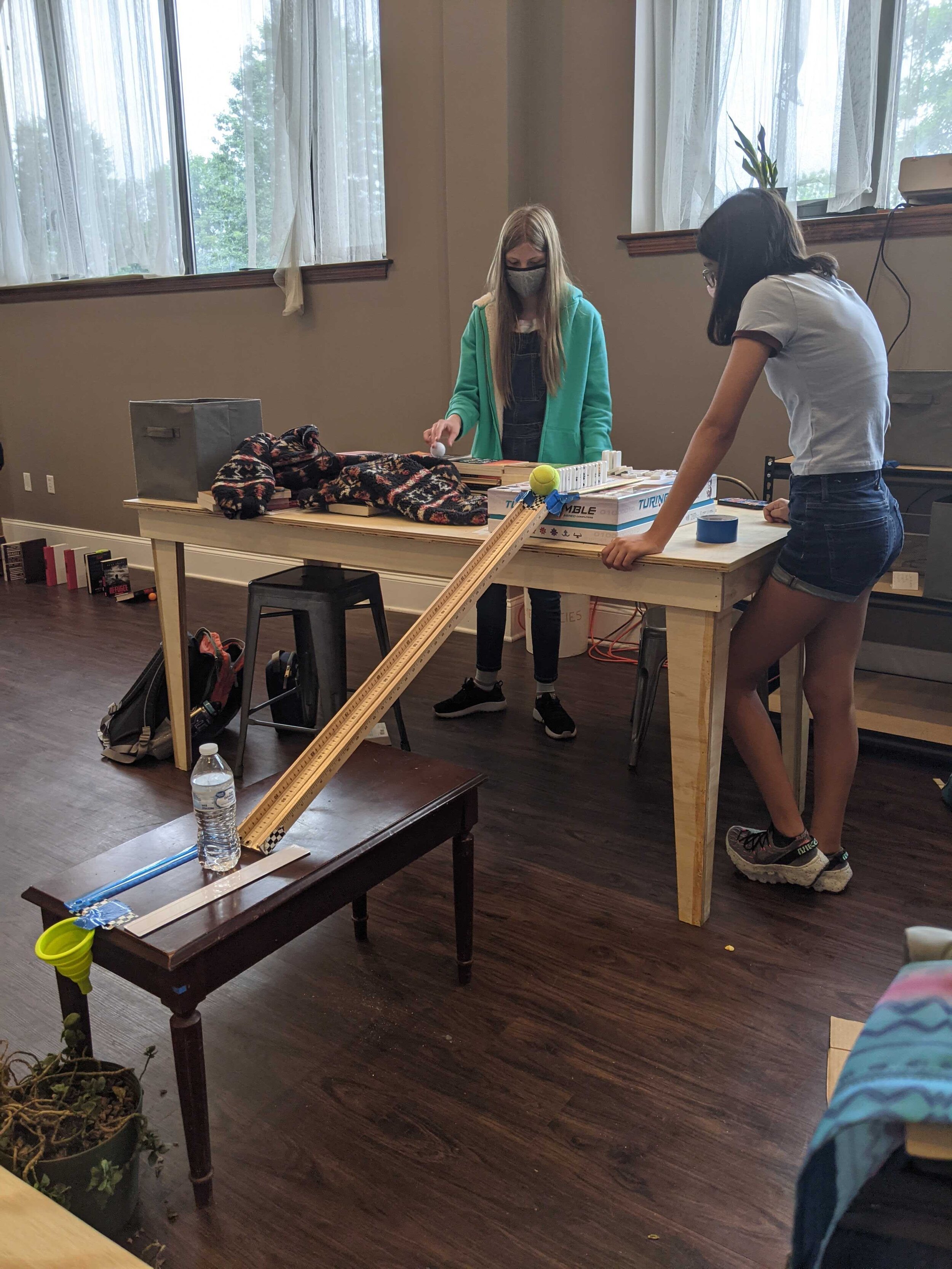 Middle school students collaborate on a “rube goldberg” build.