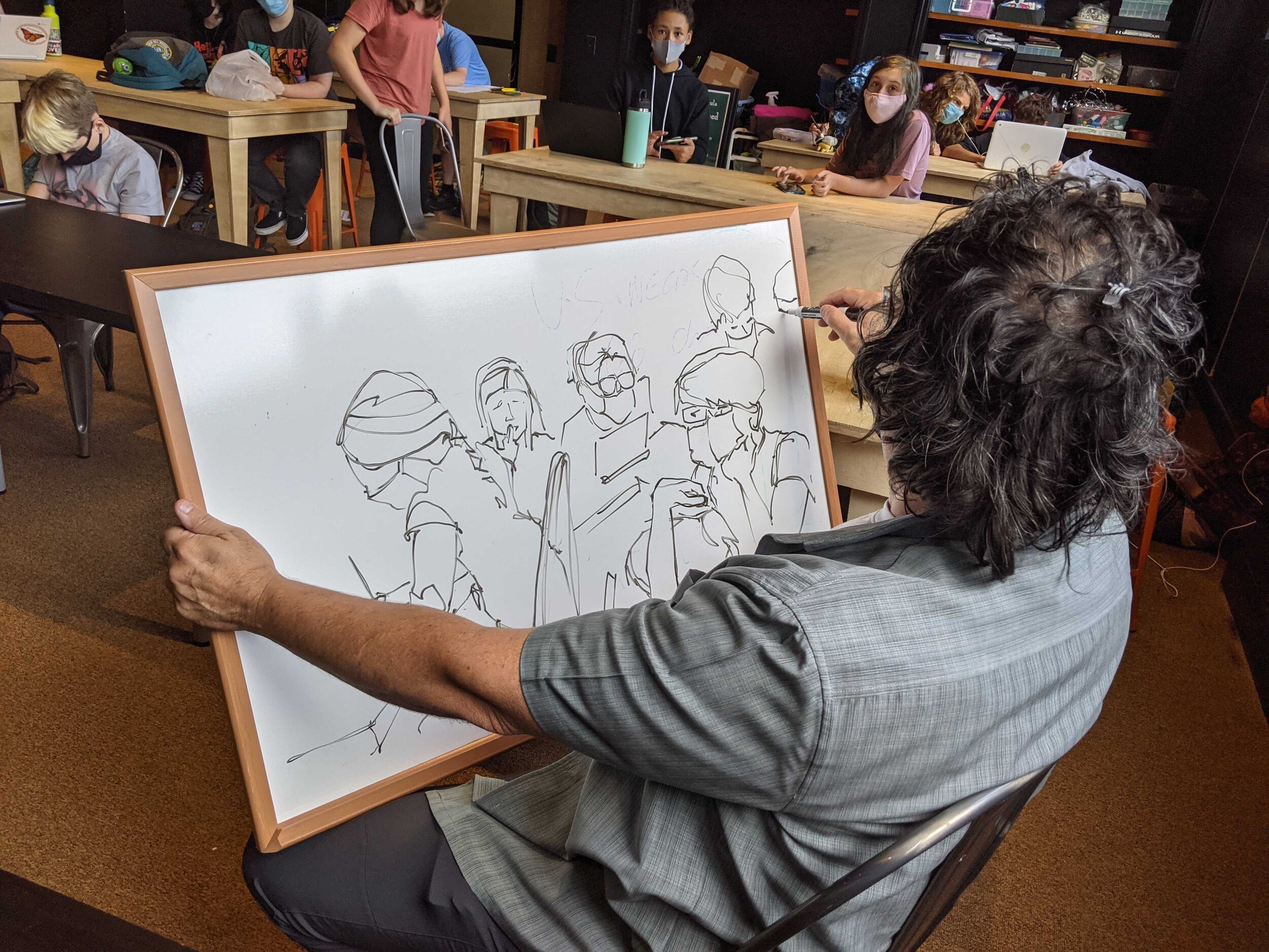 Art instructor Brian Lehman sketches, as the Middle school collaborates.