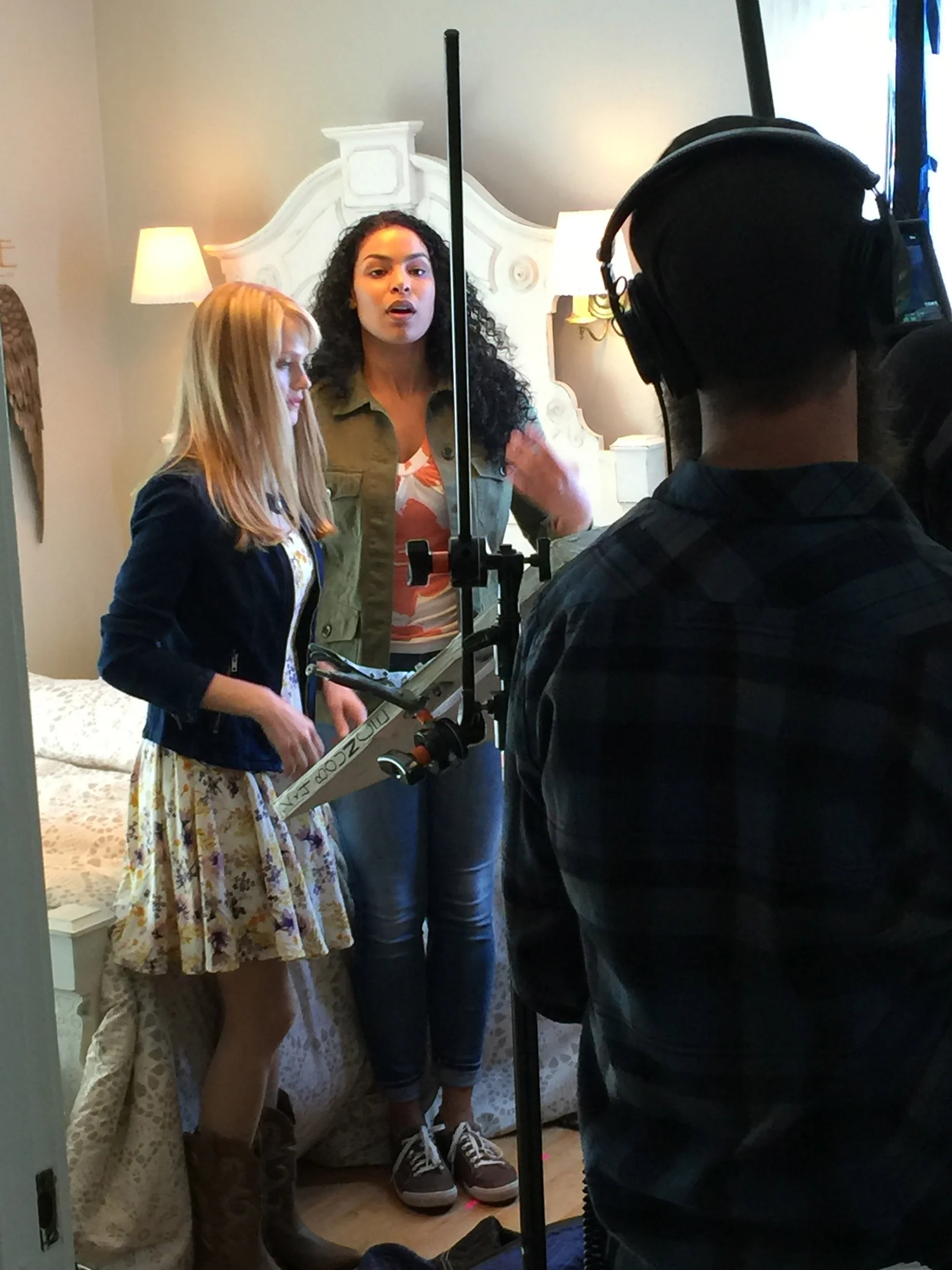 Lindsay Pulsipher & Jordin Sparks practice for a scene take on set.