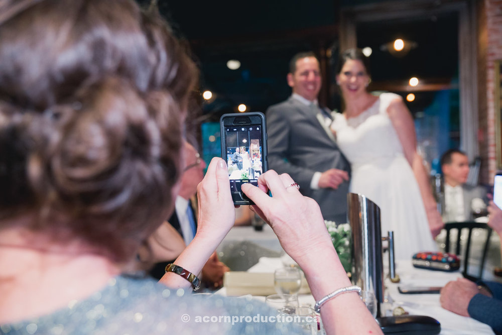 toronto-granite-brewery-wedding-guest-taking-photo-using-cell-phone-by-acornproduction.ca-100.jpg
