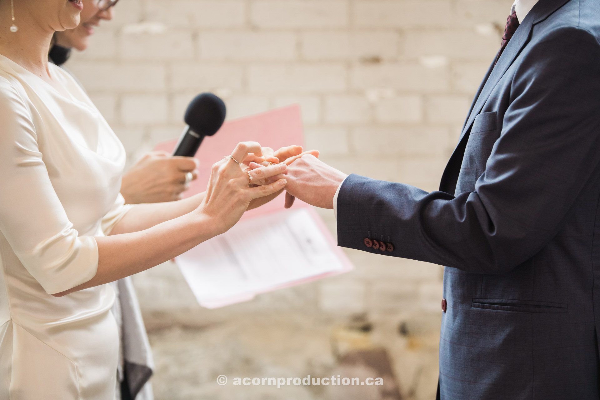 20-bride-putting-wedding-band-on-groom-hand.jpg