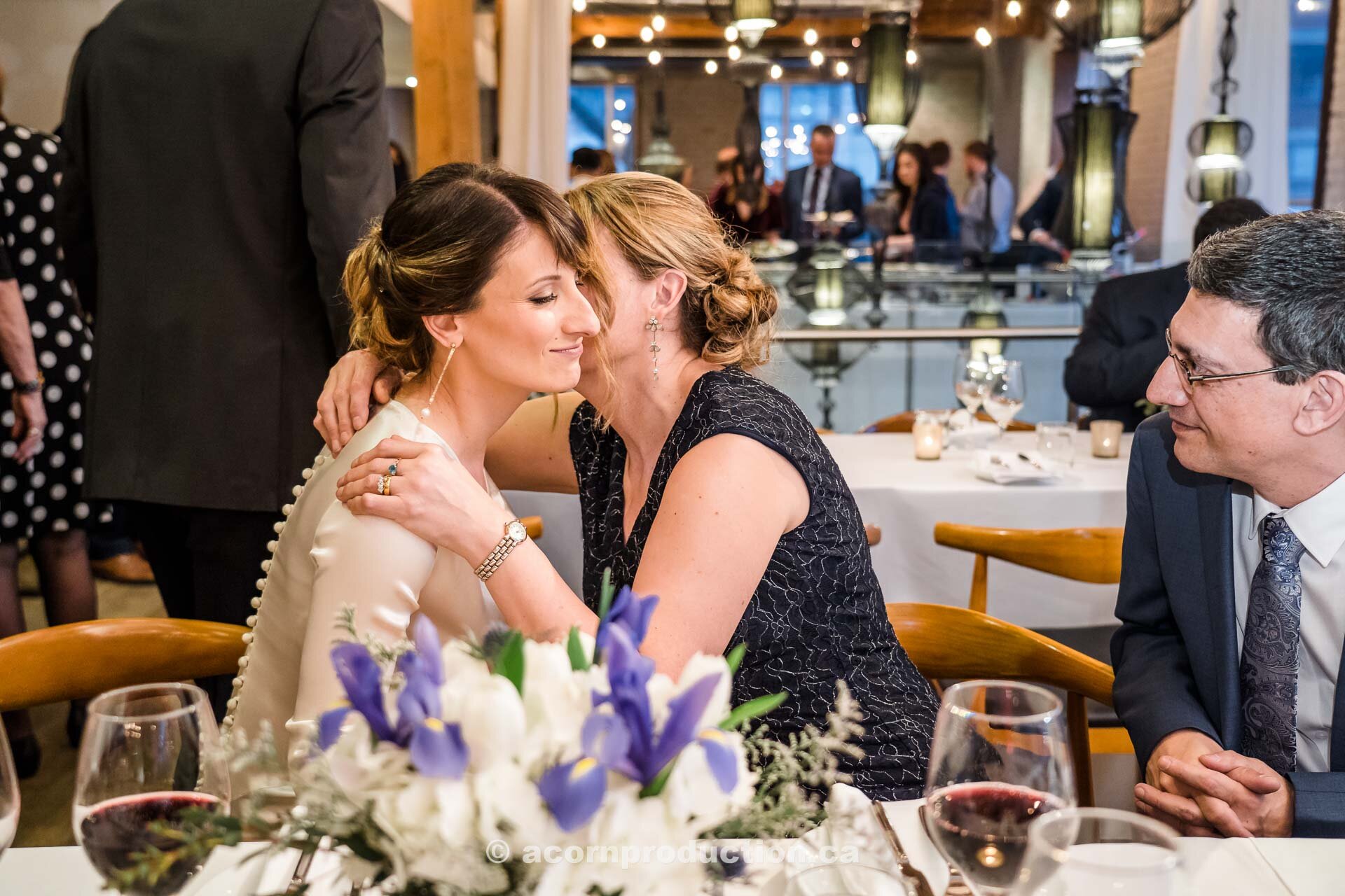 52-bride-and-mom-hugging-wedding-reception-dinner.jpg