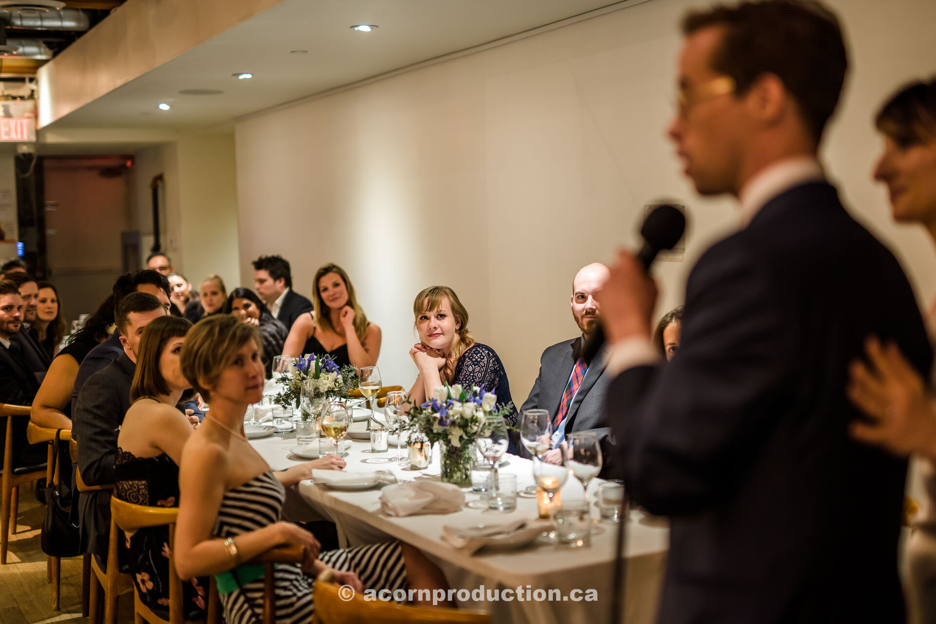 60-wedding-guests-listening-to-speech.jpg