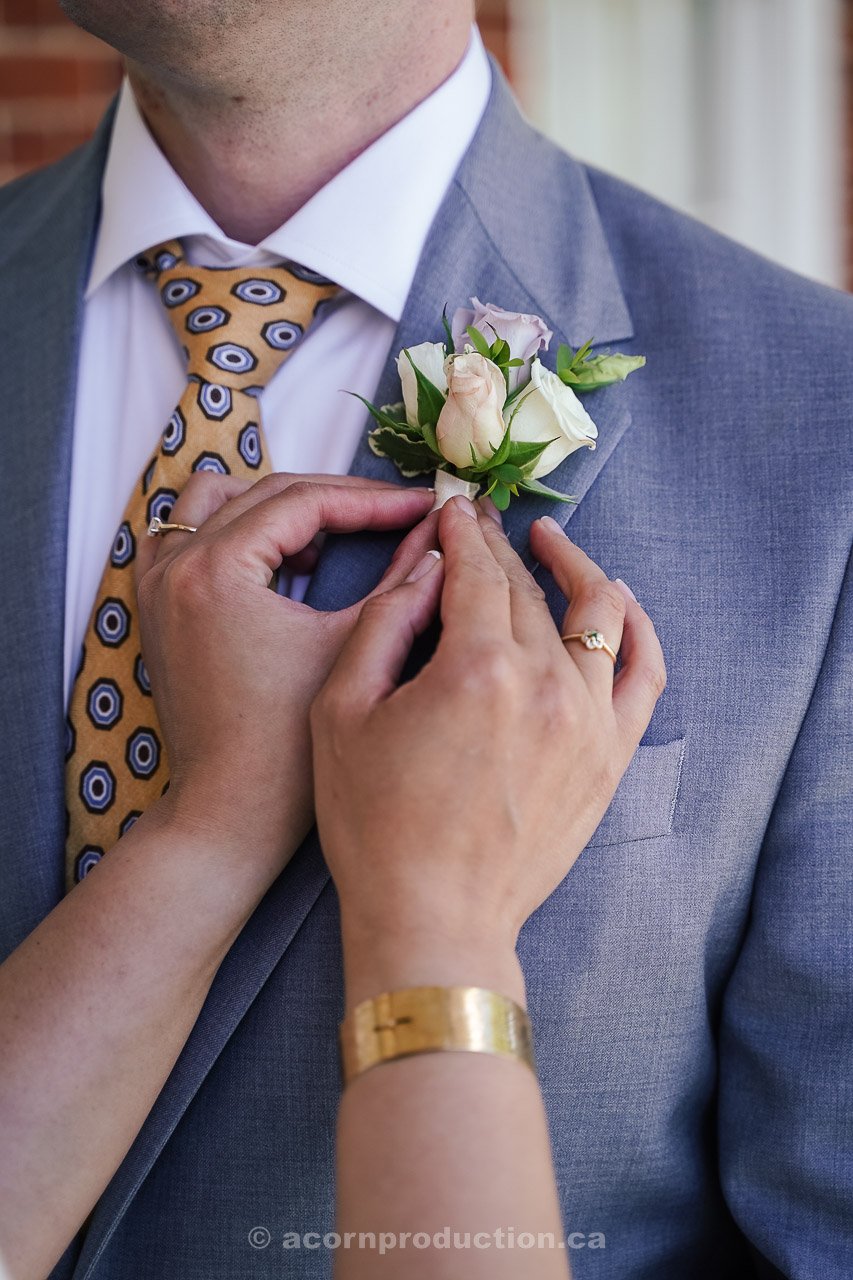 107-bride-adjusting-groom-boutonniere.jpg