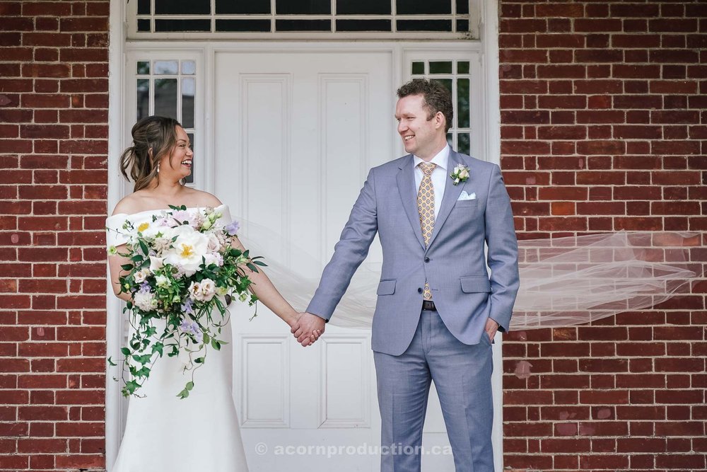 112-bride-and-groom-in-front-of-victorian-farmhouse-at-stouffville-museum.jpg