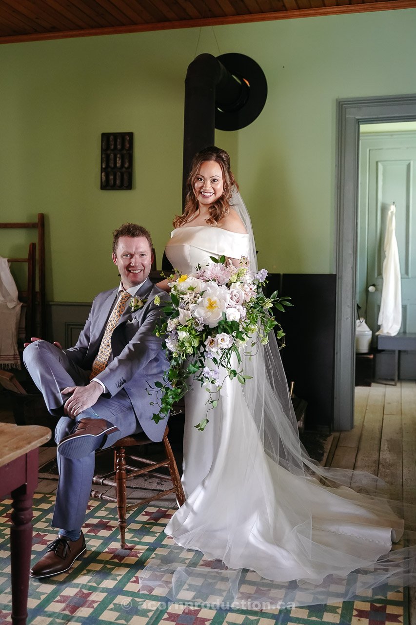 118-bride-and-groom-looking-at-camera-inside-victoria-farmhouse-stouffville-museum.jpg