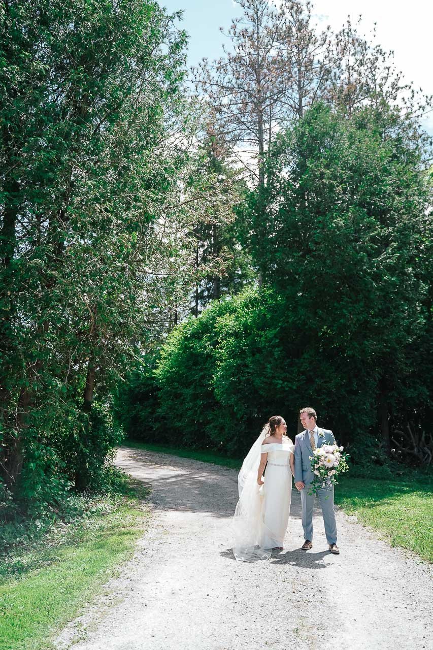 136-bride-and-groom-walking-on-trail-at-stouffville-museum.jpg