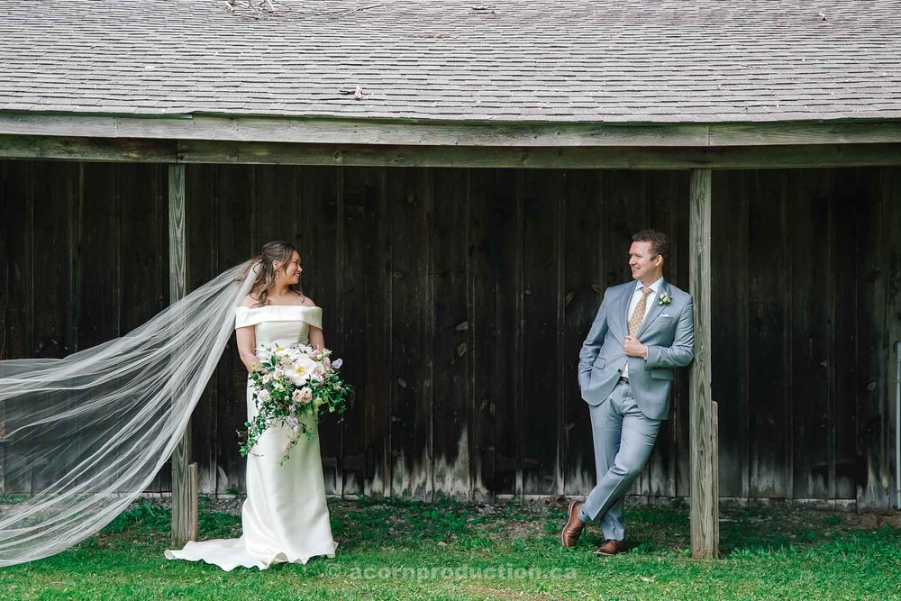 138-bride-groom-chatting-in-front-of-barn-stouffville-museum.jpg