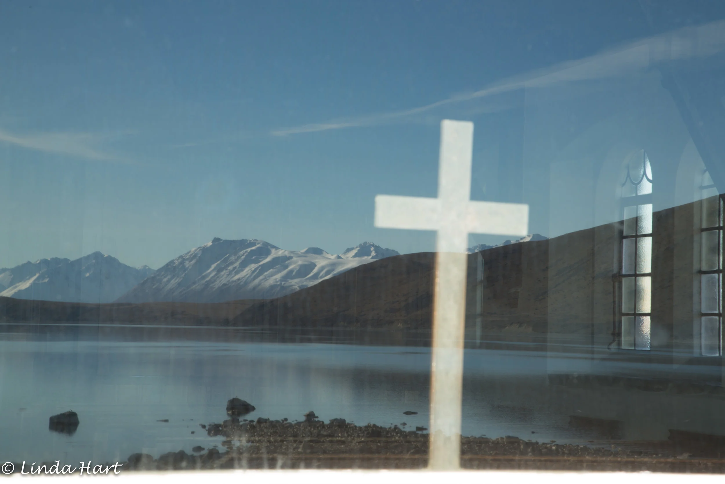 Reflection of Lake Tekapo in window of Church of the Good Shepard.