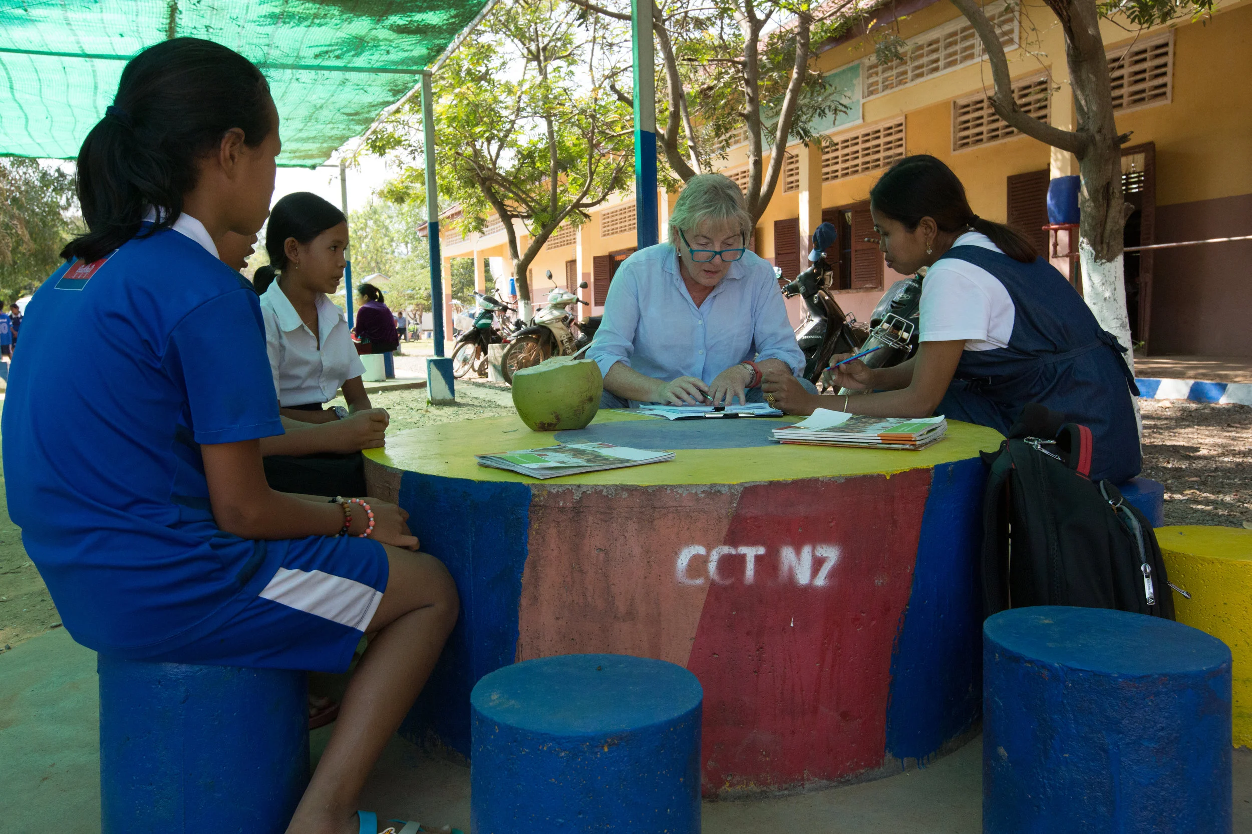 Volunteer interviews students with CCT Cambodian staff translating.