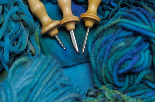 blue yarn and punch needles.jpeg