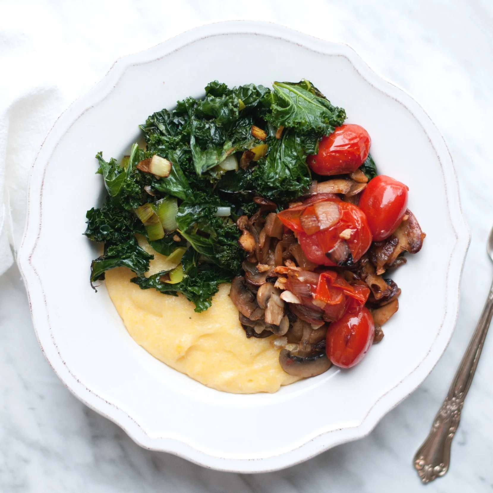 Cashew Cream Cheese Polenta topped with Wilted Greens and Veggies
