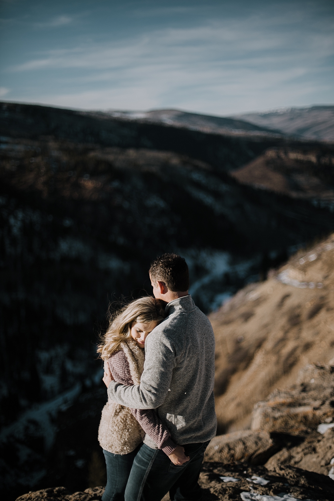 couple on cliffside, adventurous colorado engagements, colorado wedding photographer, red cliff wedding photographer, leadville wedding photographer