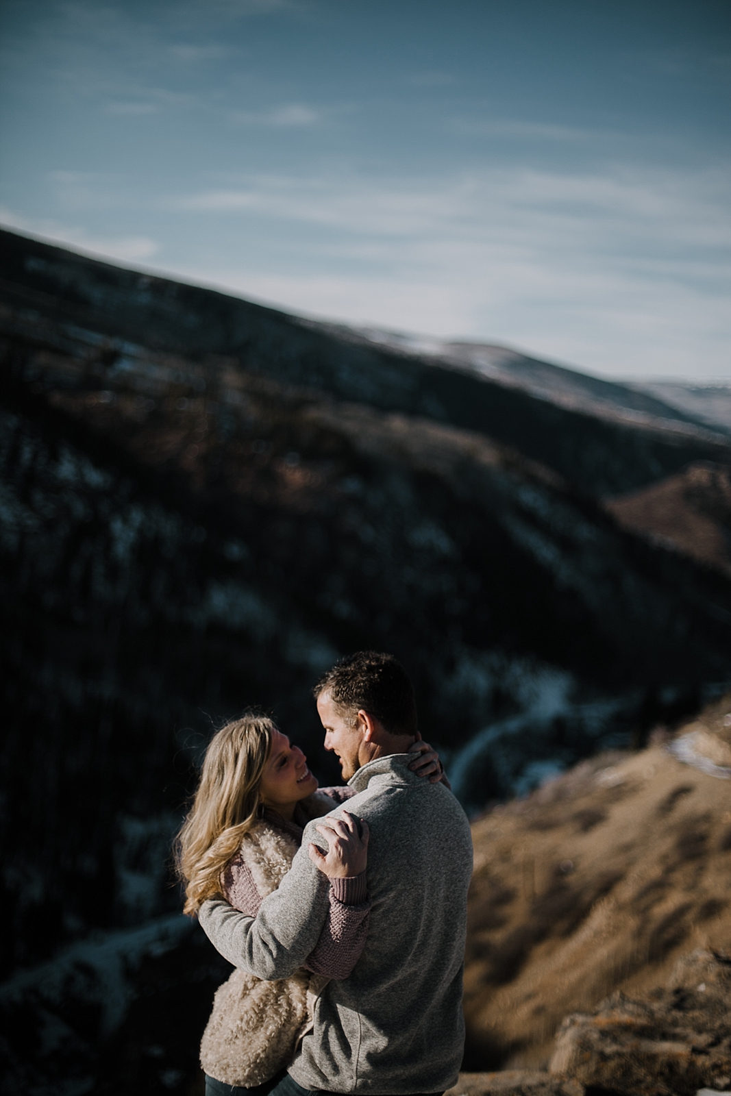 couple on cliffside, adventurous colorado engagements, colorado wedding photographer, red cliff wedding photographer, leadville wedding photographer