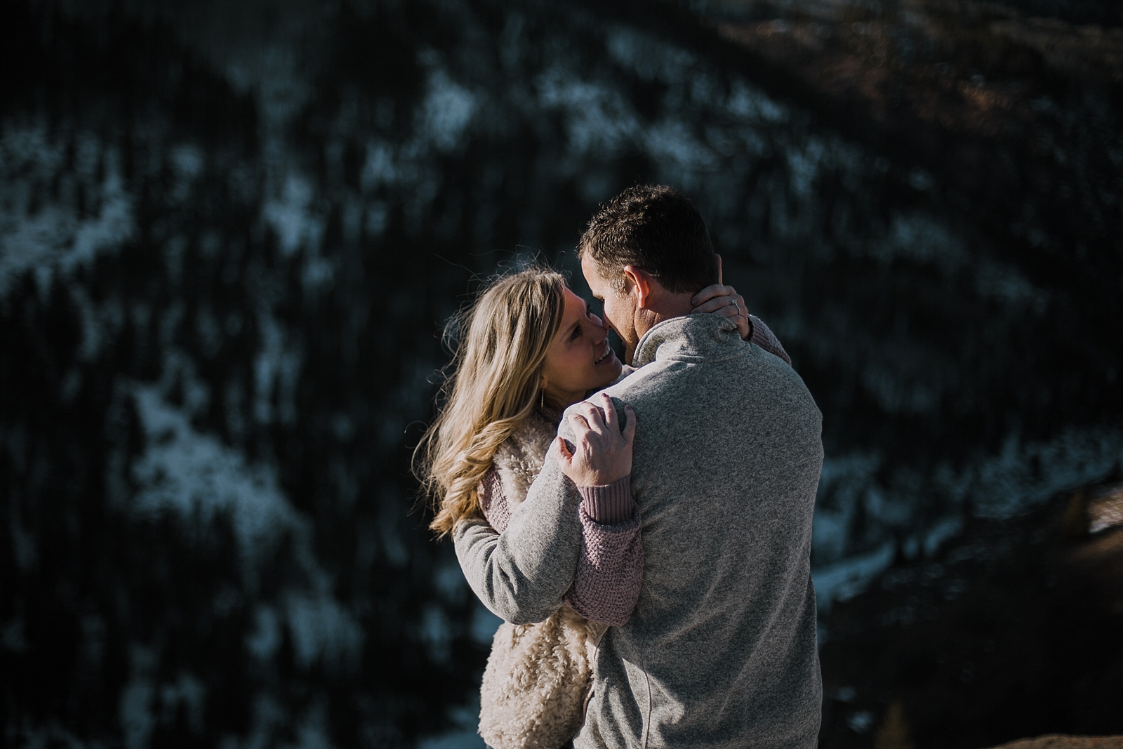 couple on cliffside, adventurous colorado engagements, colorado wedding photographer, red cliff wedding photographer, leadville wedding photographer