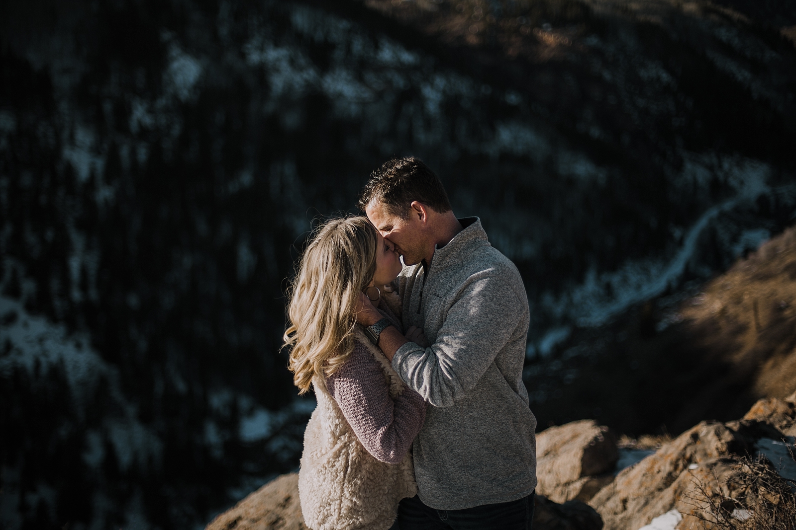 couple on cliffside, colorado hiking engagements, adventurous colorado engagements, adventurous colorado wedding photographer, red cliff wedding photographer, leadville wedding photographer