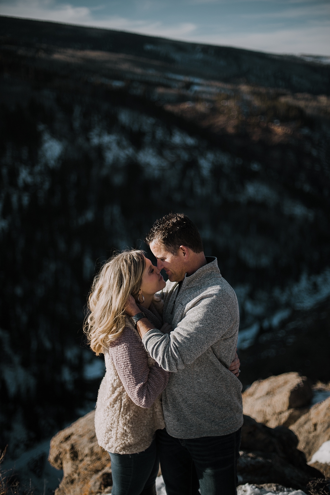 couple on cliffside, adventurous colorado wedding photographer, adventurous hiking engagements, hiking engagements, red cliff wedding photographer, leadville wedding photographer