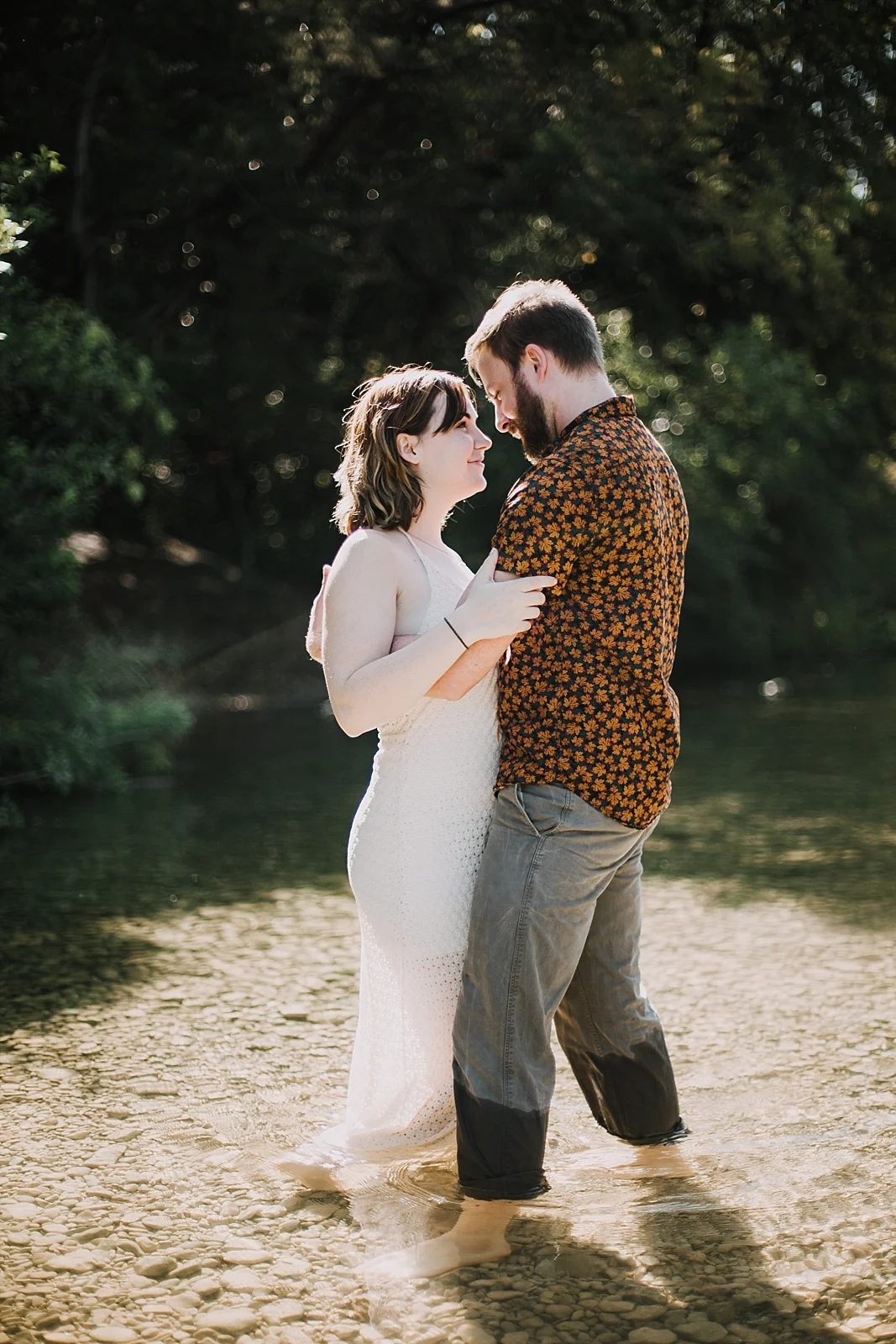 couple wading in the green belt, austin texas wedding photographer, the alexander at creek road wedding photographer, south africa wedding photographer, paris france wedding photographer