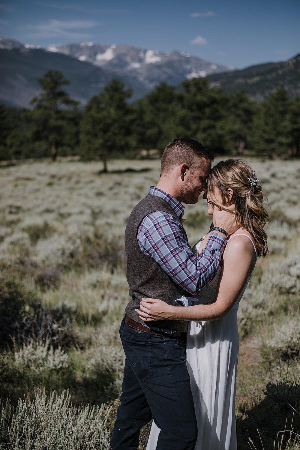 groom kissing bride, RMNP elopement ceremony, rocky mountain national park elopement, 3M curves elopement, self solemnizing, self solemnization, long's peak, summer elopement, estes park elopement