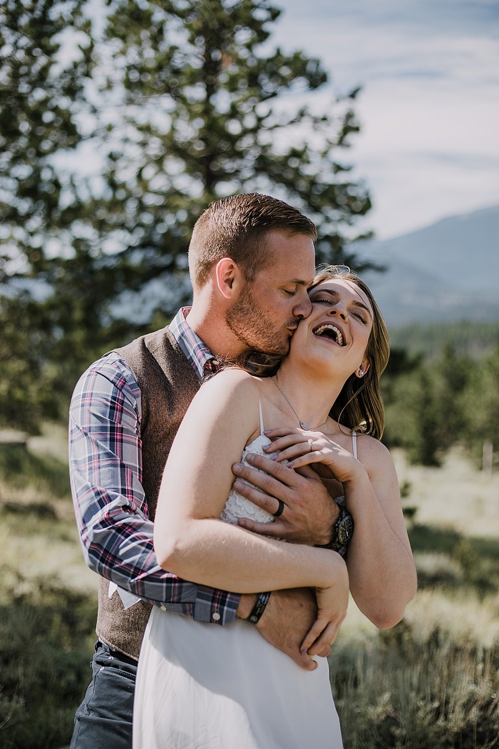 groom kissing bride, RMNP elopement ceremony, rocky mountain national park elopement, 3M curves elopement, self solemnizing, self solemnization, long's peak, summer elopement, estes park elopement