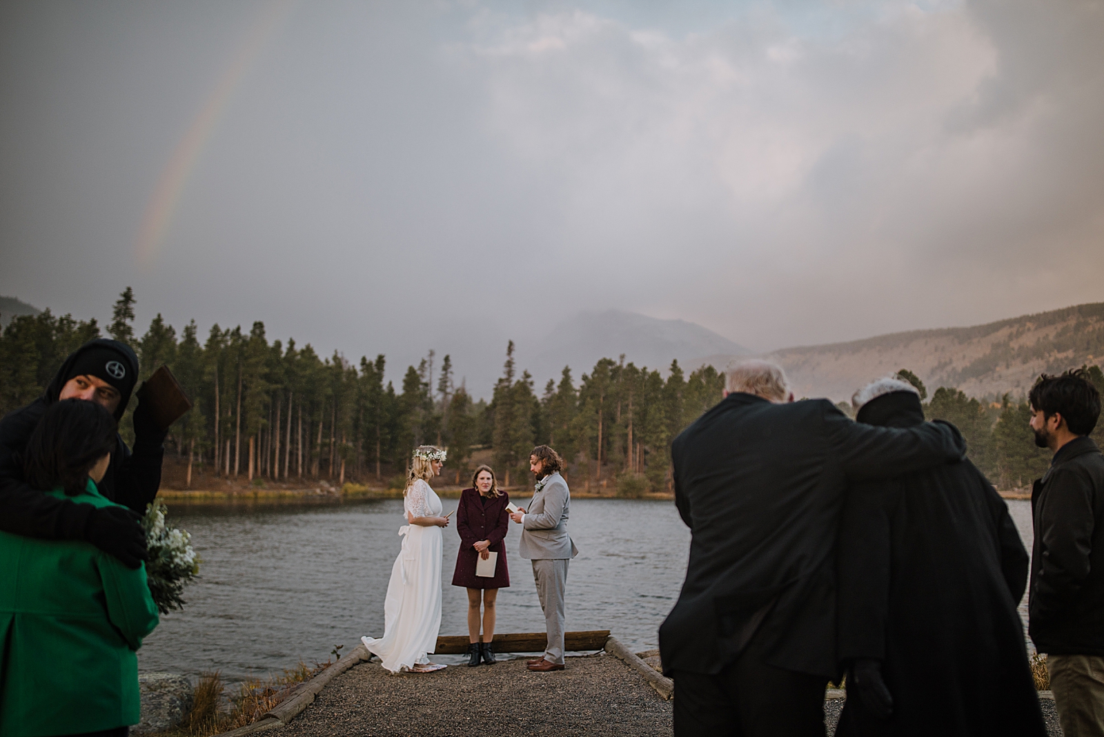 bride and groom in the rain, sprague lake dock elopement, sunrise elopement, colorado elopement, sprague lake elopement, rocky mountain national park elopement, adventurous colorado hiking elopement