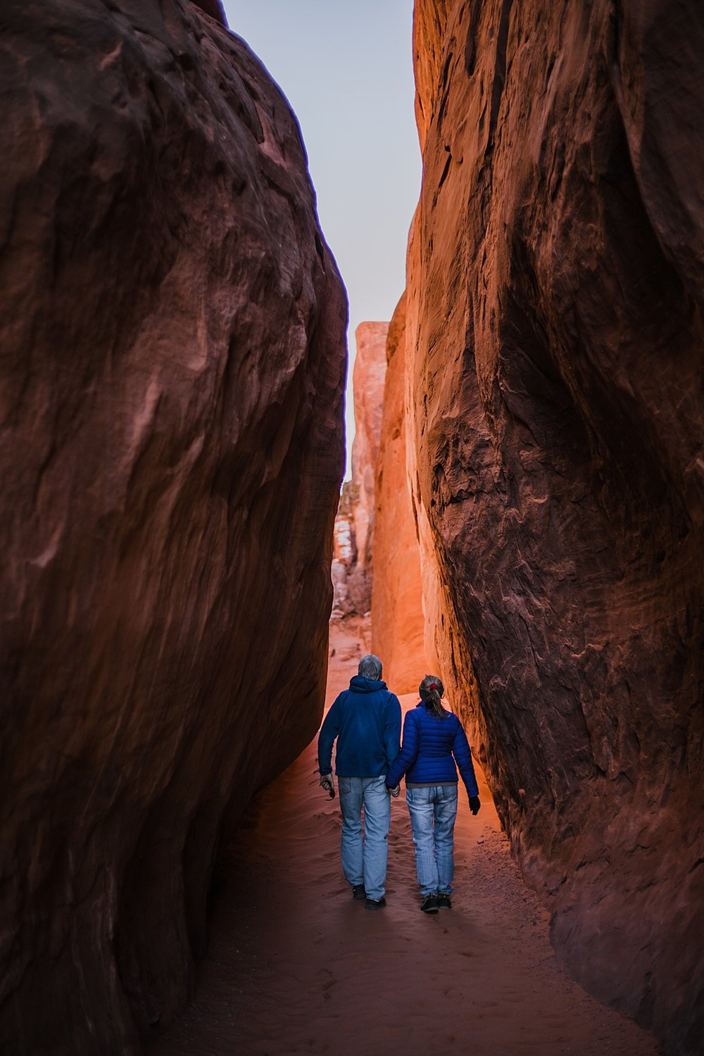 couple exploring arches national park, moab utah, engagements, desert love, hiking in moab, hiking in arches national park, arches national park elopement