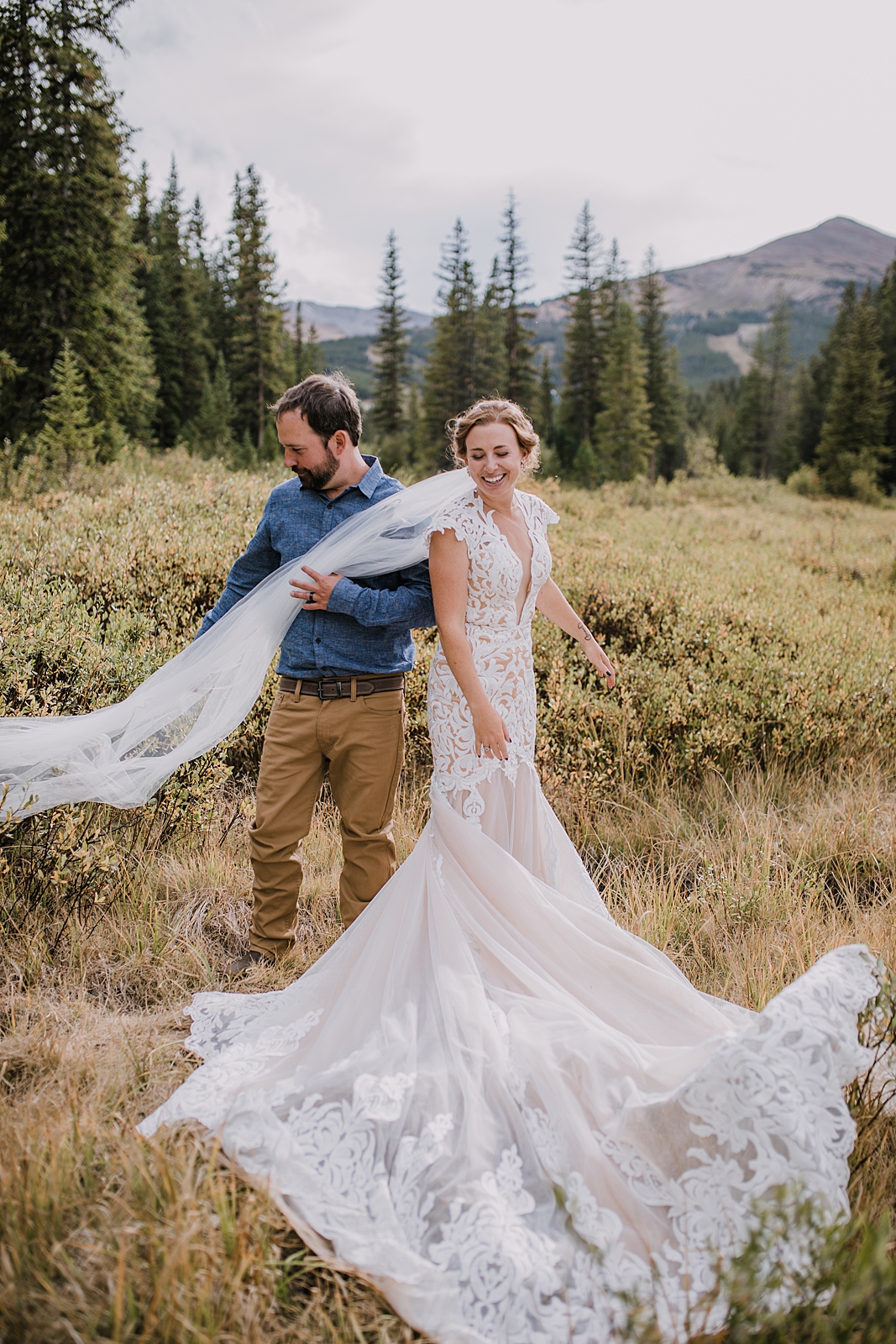 groom holding veil, hiking the cucumber gulch trail in breckenridge colorado, breckenridge nordic center summer wedding, summer wedding in breckenridge colorado, hiking the breckenridge nordic trails