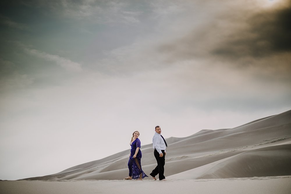 couple hiking the great sand dunes near crestone colorado, great sand dunes national park hiking, great sand dunes national park sunset elopement, elope at the great sand dunes