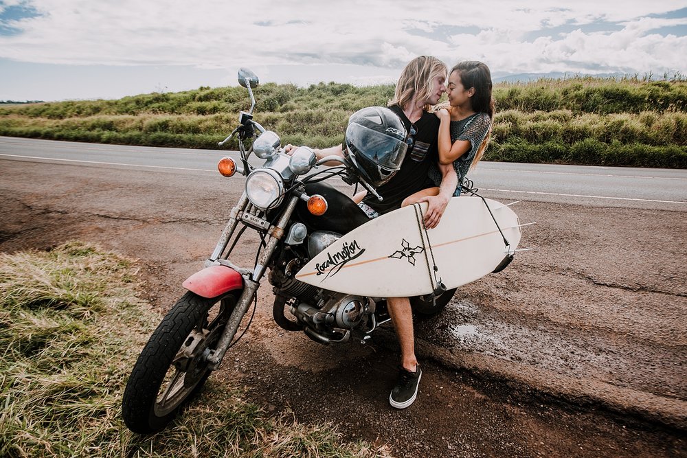 couple riding motorcycle with surfboard in maui hawaii, surfboard on a motorcyle, maui hawaii engagements, maui hawaii elopement, paia surfing, motorcycle engagements