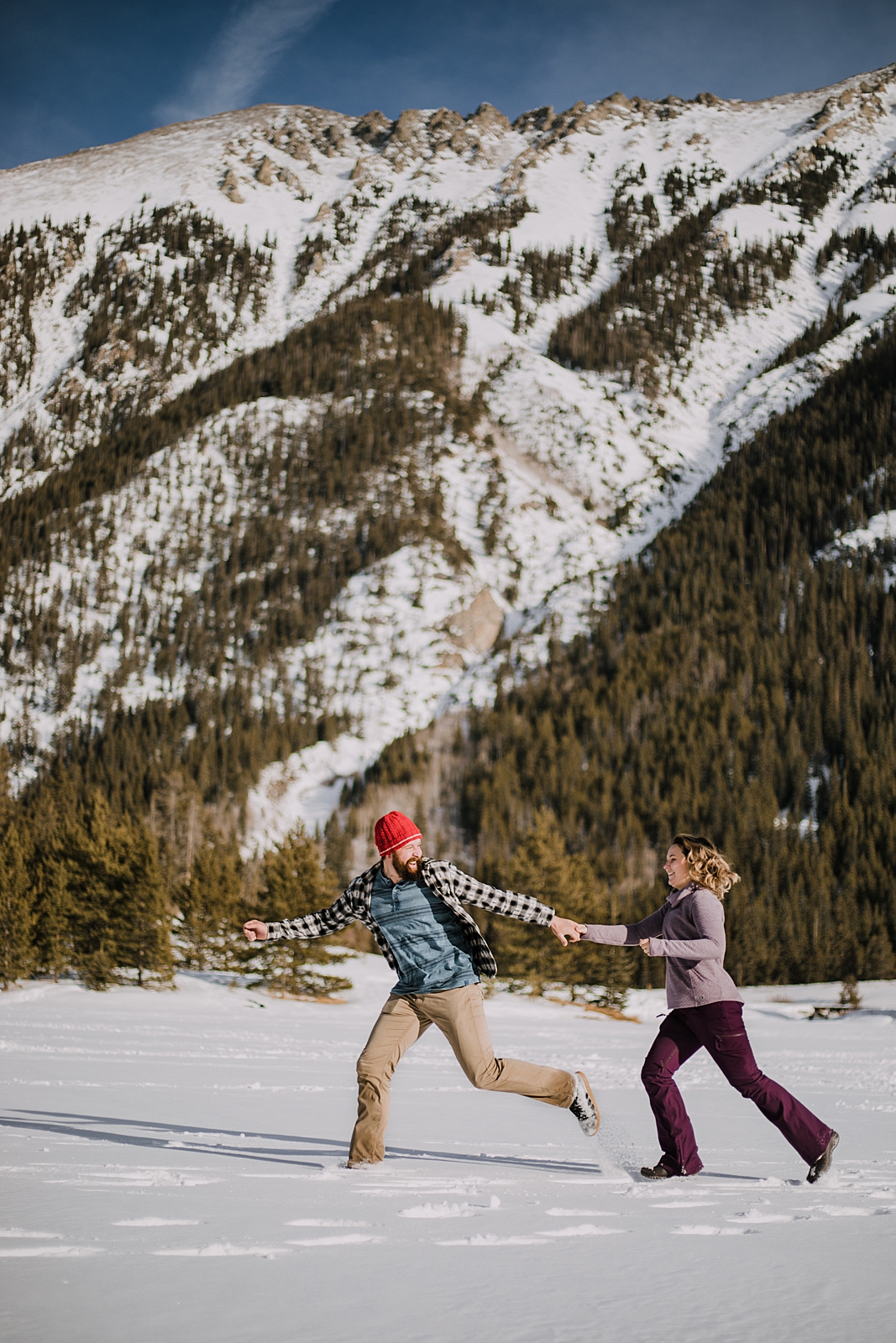 couple playing in the snow, officers gulch colorado elopement, hiking officers gulch near frisco and copper colorado, snowy colorado engagements