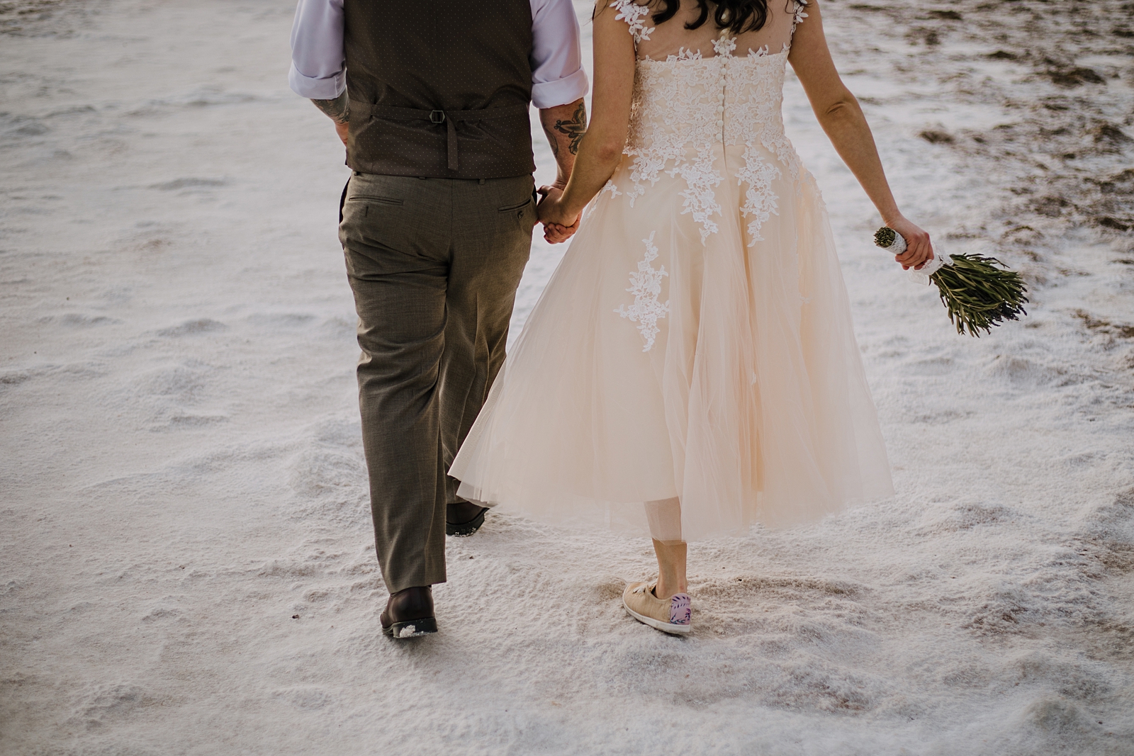 couple hiking the salt flats, death valley national park elopement, elope in death valley, badwater basin elopement, hiking in death valley national park, sunset at badwater basin