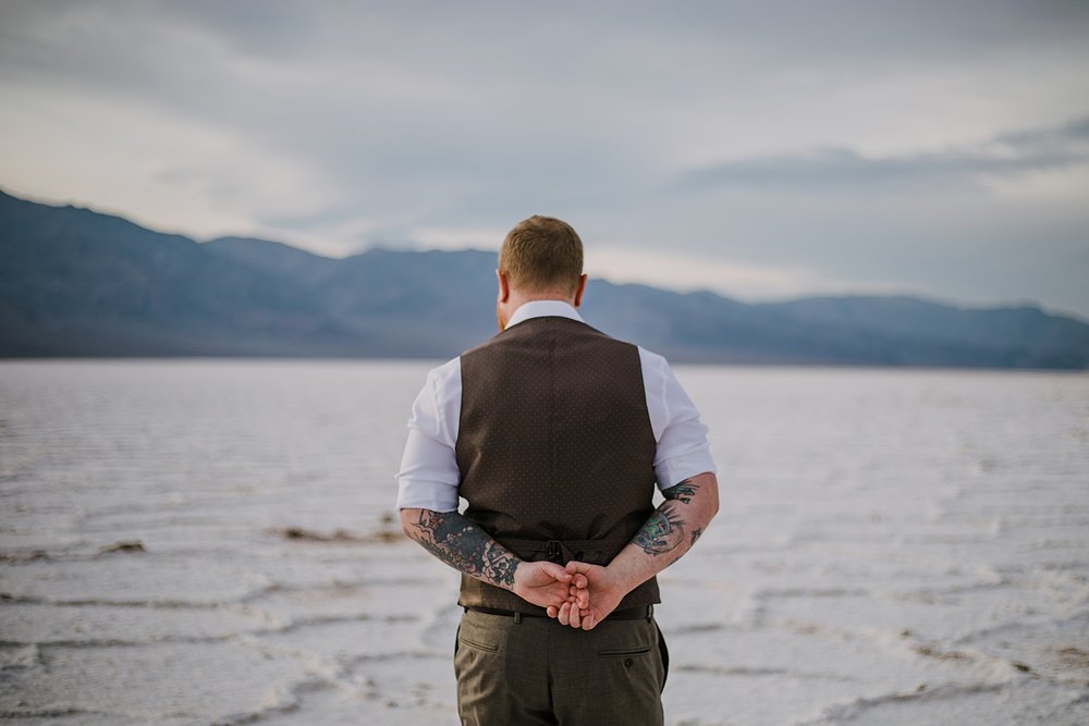 groom on the salt flats, death valley national park elopement, elope in death valley, badwater basin elopement, hiking in death valley national park, sunset at badwater basin