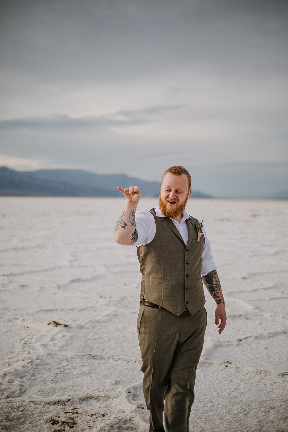 salt bae groom on the salt flats, death valley national park elopement, elope in death valley, badwater basin elopement, hiking in death valley national park, sunset at badwater basin