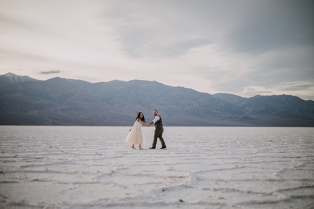 hiking across the salt flats, death valley national park elopement, elope in death valley, badwater basin elopement, hiking in death valley national park, sunset at badwater basin