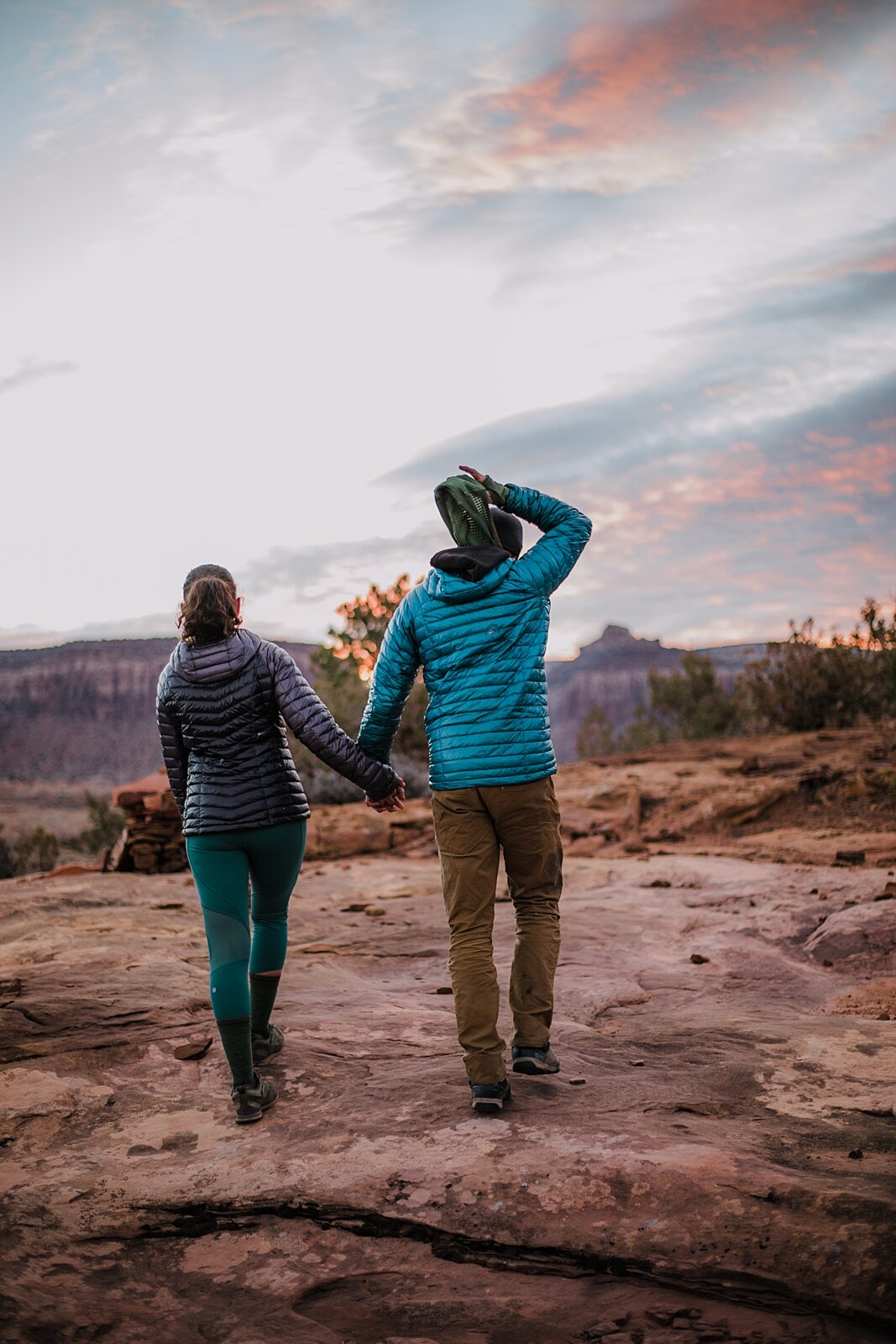 couple walking hand in hand, indian creek climbing area, canyonlands national park, moab utah engagements, sunrise in moab utah