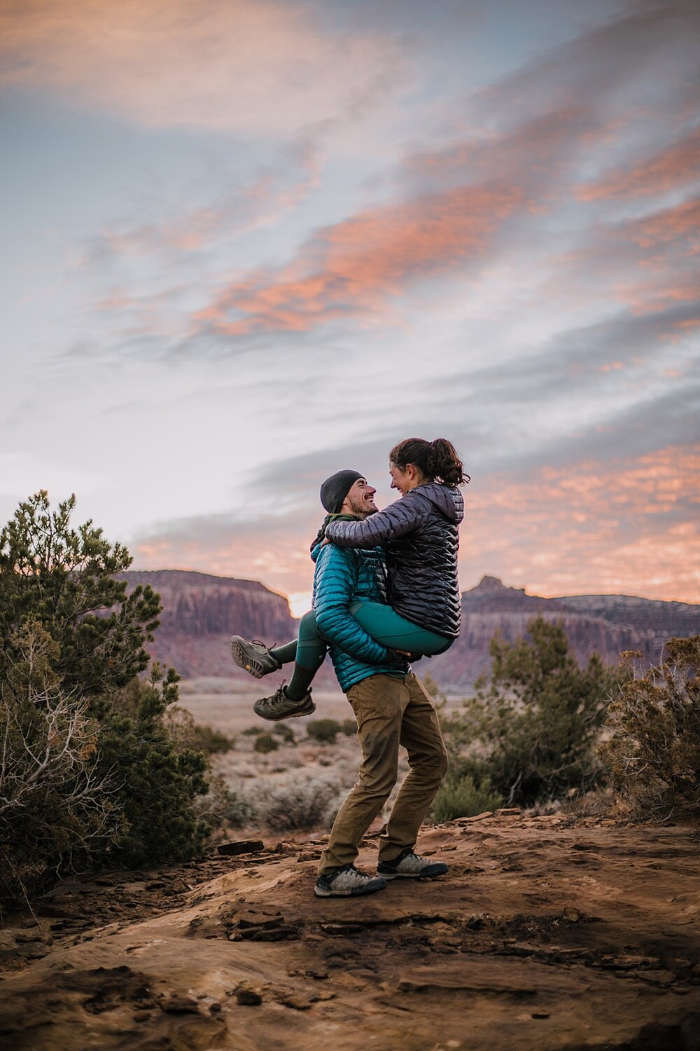 couple hiking through the desert, indian creek climbing area, canyonlands national park, moab utah engagements, sunrise in moab utah