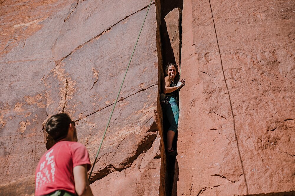 couple climbing together in indian creek near monticello utah, indian creek climbing area, canyonlands national park, moab utah climbing engagements, crack climbing moab utah