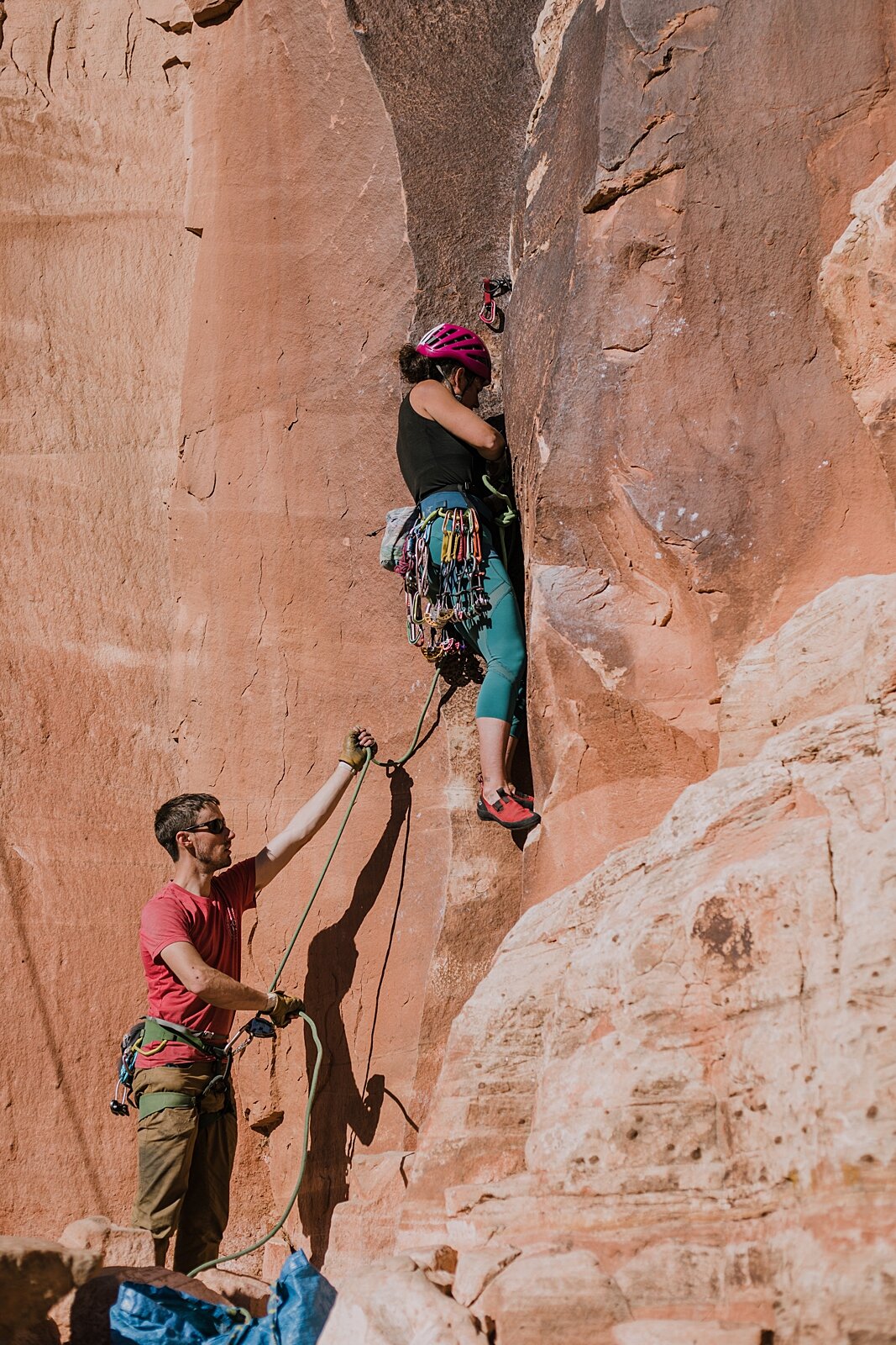 couple climbing together in indian creek near monticello utah, indian creek climbing area, canyonlands national park, moab utah climbing engagements, crack climbing moab utah