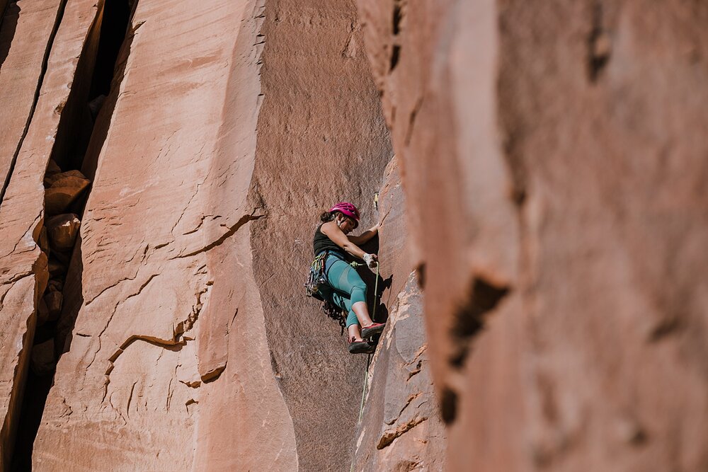 couple climbing together in indian creek near monticello utah, indian creek climbing area, canyonlands national park, moab utah climbing engagements, crack climbing moab utah