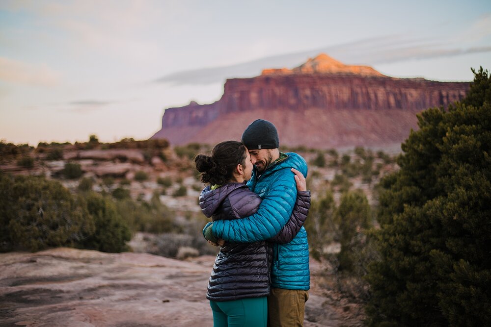 couple taking in the view of indian creek, indian creek climbing area, canyonlands national park, moab utah engagements, sunrise in moab utah