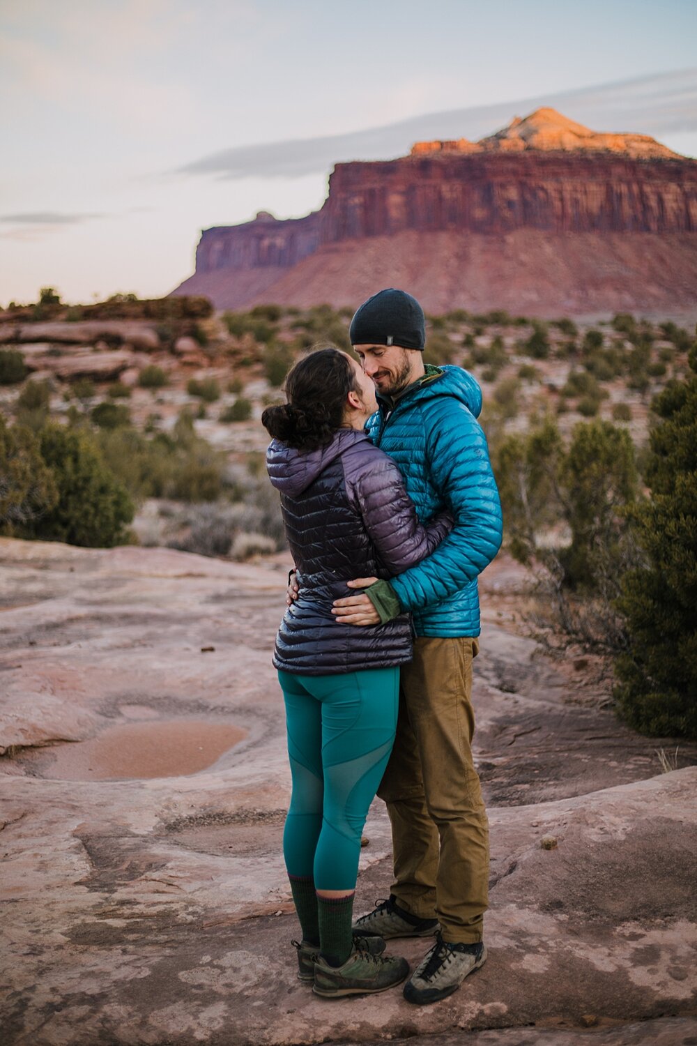 couple taking in the view of indian creek, indian creek climbing area, canyonlands national park, moab utah engagements, sunrise in moab utah