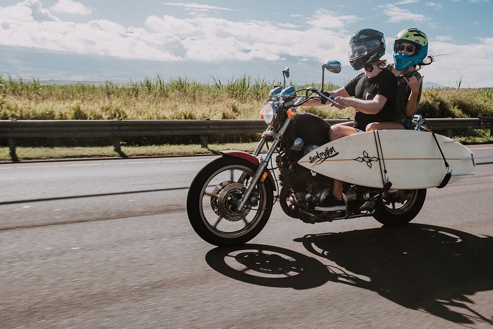 motorcycle driving on the road to hana, couple riding a motorcycle, maui hawaii photographer, maui hawaii surfing, surfing at ho'okipa beach, ho'okipa beach engagements, motorcycle engagements