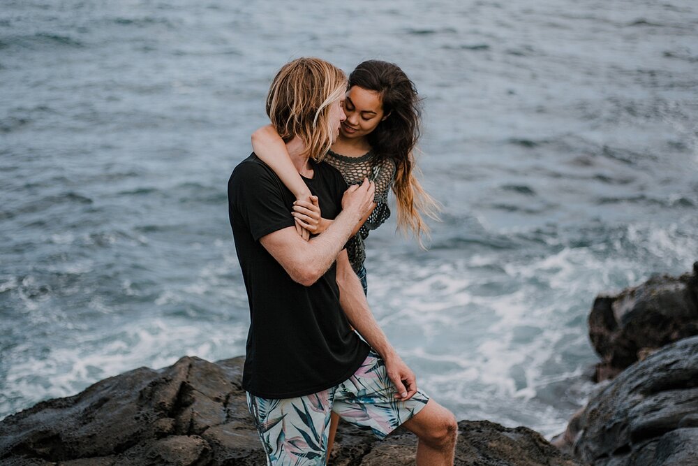 couple standing on lava rocks on ho'okipa beach, couple hiking ho'okipa, maui hawaii photographer, maui hawaii surfing, surfing at ho'okipa beach, ho'okipa beach engagements, motorcycle engagements