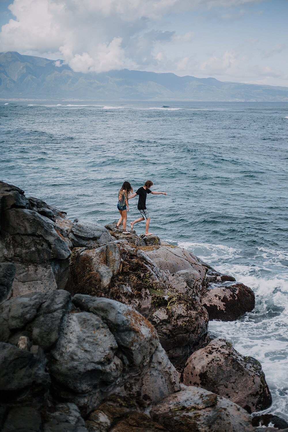 hiking on volcanic lava rocks on ho'okipa beach, couple hiking ho'okipa, maui hawaii photographer, maui hawaii surfing, surfing at ho'okipa beach, ho'okipa beach engagements, motorcycle engagements